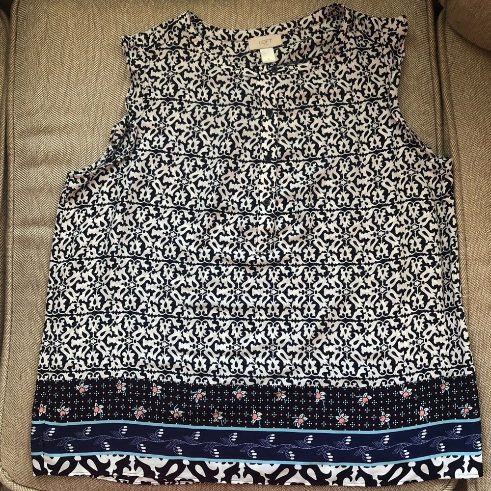 Black/white top, decorative trim at hem and 3/4 button front, 100% polyester.
